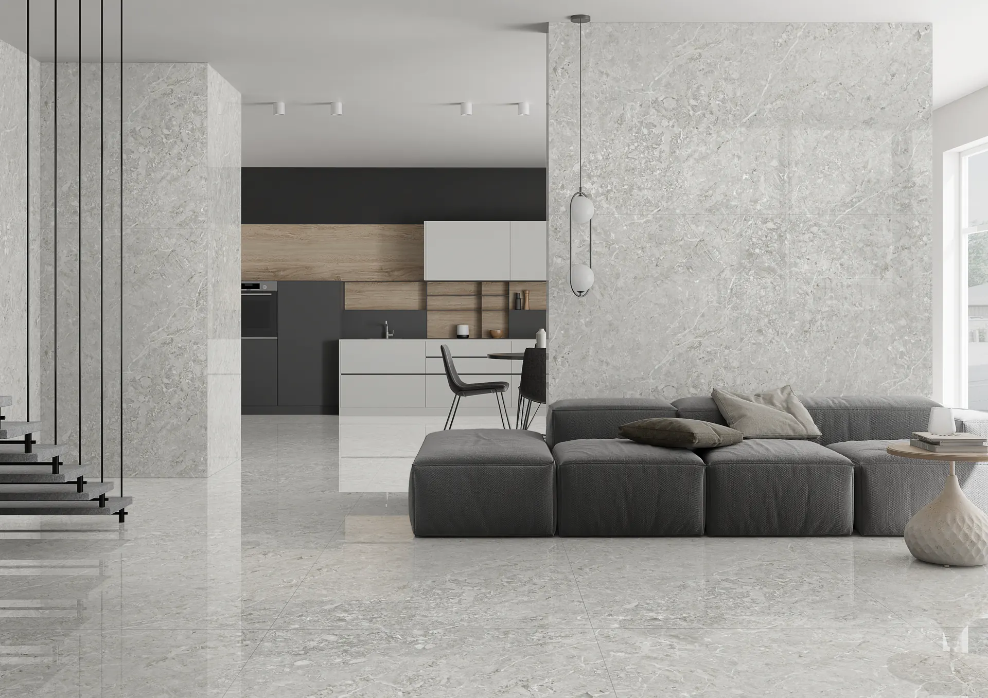 Perlato Gris tiles in soft grey across the floor and walls of a bright open kitchen and living space